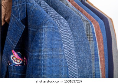 Men's jackets on hangers in a men's business clothes shop.