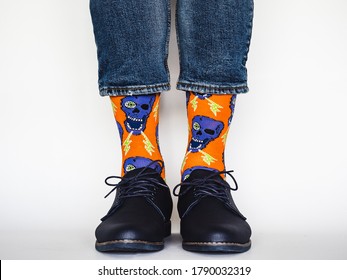 Men's legs, trendy shoes, blue jeans and variegated, long socks on a white, isolated background. Close-up. Concept of style and elegance - Powered by Shutterstock