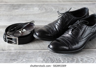 Men's modern fashion. Classic leather shoes, belt and sunglasses.