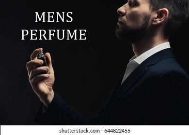 Men's Perfume. Man Using Cologne And Text On Dark Background