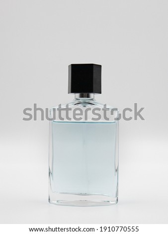 Men's perfume on a gray uniform background