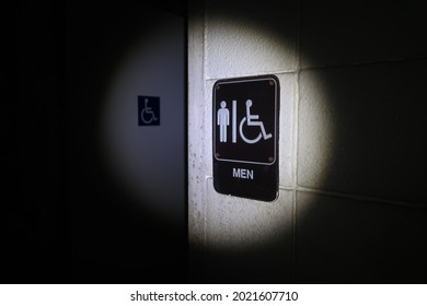 Mens Room Sign Lit By A Flashlight. Abandoned Building. Low Light.                               