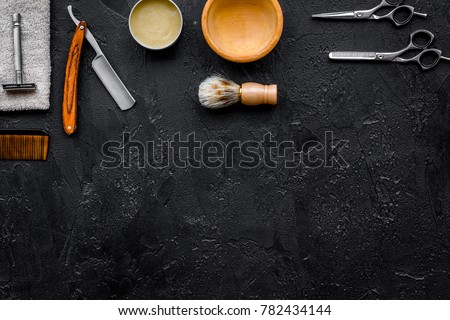 Men's shaving. Razor and brush on black background top view copyspace