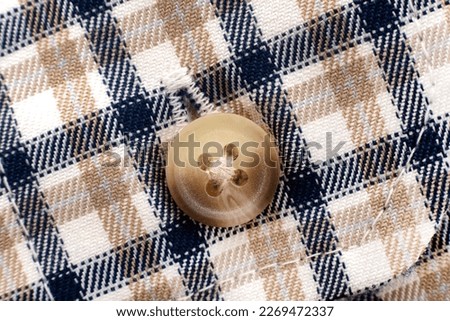 Men's shirt. Plaid shirt sleeve with buttons. Piece of clothing. Button