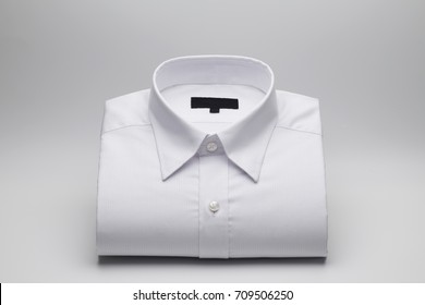 Men's Shirts Folded On A White Background