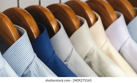 Men's shirts hang on hangers in the store, men's clothing for the office concept background - Powered by Shutterstock