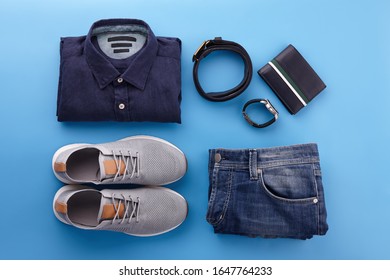 Mens Summer Casual Clothing Outfits And Accessories Flat Lay On Blue Background, Top View