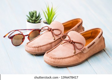 Men's summer shoes on blue wooden board - Shutterstock ID 1396478417