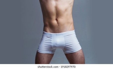 Mens underwear. Guy in white shorts. Male muscular body in underpants.