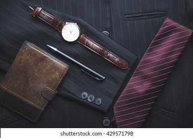 Men's wallet, watch, tie on suit