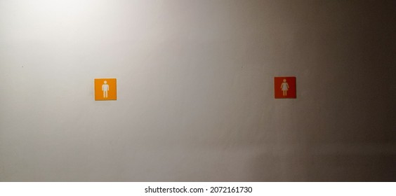 Men's And Women's Restroom Sign On The Wall