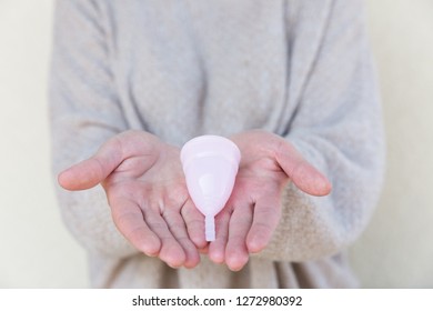 The menstrual cup is holding by woman hands. Selective focus. - Shutterstock ID 1272980392