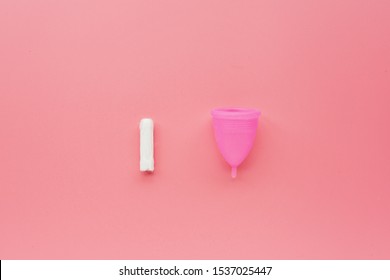 Menstrual Cup And Tampon On Pink Background. Alternative Feminine Hygiene Product During The Period. Women Health Concept. Copy Space. Eco Friendly Concept, Zero Waste Product. Flat Lay, Mockup