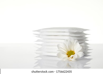 Menstrual Sanitary Pads Isolated On White Background. Feminine Hygiene Products And Chamomile Flower.