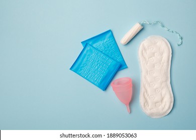 Menstruation Products, Intimate Hygiene, Women Gynecological Health, Sanitary Pads, Tampon And Menstruation Cup On Blue Background