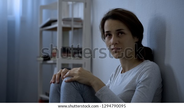 Mental disease patient sitting on floor,\
hospital therapy,\
schizophrenia