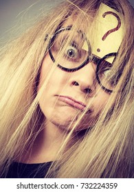 Mental effort, finding problem solution face expression concept. Tired crazy woman wearing nerd geek eyeglasses exhausted after intensive thinking having question mark on her forehead and messy hair