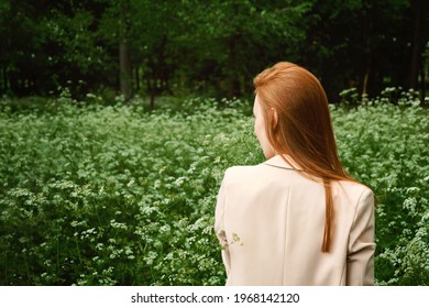 Mental Health Awareness Month, Behavioral Health Care. Post COVID-19 Pandemic Mental Health Challenges. Red-haired Young Woman On Green Nature Trees And Flowers Background