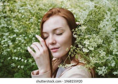 Mental Health Awareness Month, Behavioral Health Care. Post COVID-19 Pandemic Mental Health Challenges. Red-haired Young Woman On Green Nature Trees And Flowers Background