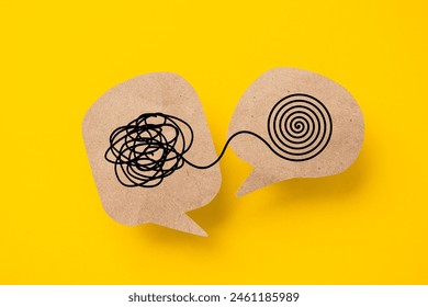 Mental health, brain disorder concept. World mental health day, Alzheimer and Psychology concept. Tangle of thoughts and clear line on brown speech bubble with yellow background