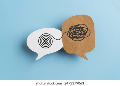 Mental health, brain disorder, World mental health day, Alzheimer, Psychology concept. Tangle of thoughts and clear line on real brown and white speech bubble paper cut with blue background