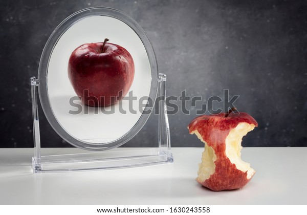 Mental Health\
Concept- Apple reflection on\
mirror.