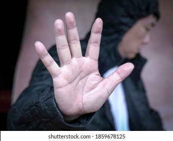 Mental Health Concept. Depressed Man Waving Hand To Push Away Or Refuse Help.