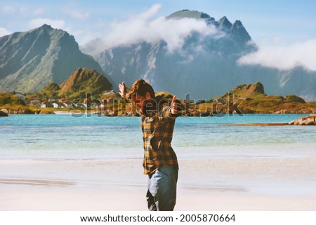 Mental health outdoor man traveler hands raised enjoying nature view active healthy lifestyle adventure vacations in Norway happy emotions harmony concept