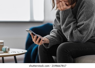 mental health, psychological help and depression concept - close up of stressed woman with medicine pills on table holding smartphone at home - Powered by Shutterstock