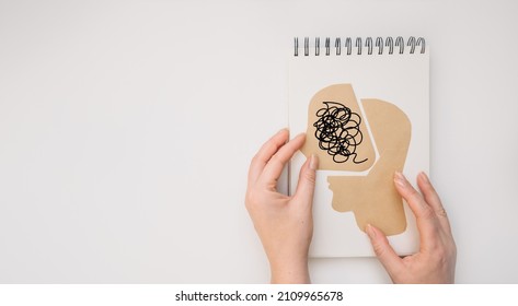 MENTAL HEALTH Mental Psychological Stress Management and Psychological trauma Health. Hand holding paper cut head on white background - Shutterstock ID 2109965678