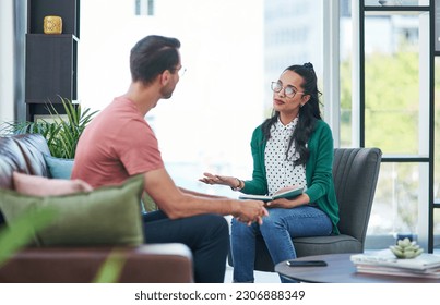 Mental health, therapy or counseling with a woman psychologist and male patient talking in her office. Psychology, wellness and trust with a female doctor or shrink consulting a man for healing - Powered by Shutterstock