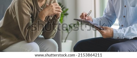mental health treatment concept. Stressed asian patient talking with personal psychologist in therapist session have a burnout in work at clinic in office room.