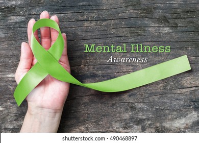 Mental Illness Awareness With Lime Green Ribbon Color  On Helping Hand