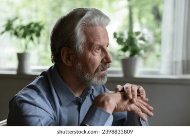 Mental problem. Unhealthy mature grey haired man retiree spend time alone stare straight before himself suffer of senile dementia alzheimer disease. Depressed older male look away feel sorrow solitude - Powered by Shutterstock