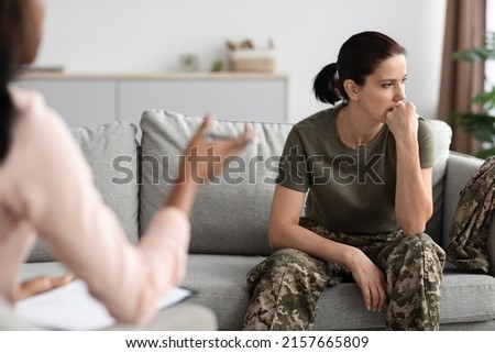Mental Therapy. Portrait Of Upset Pensive Female Soldier Attending Meeting With Psychologist, Thoughtful Woman In Military Uniform Sitting On Couch And Looking Away, Suffering Depression Or PTSD