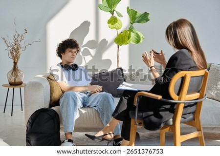 Mental therapy session, young guy talking with female psychologist, in office
