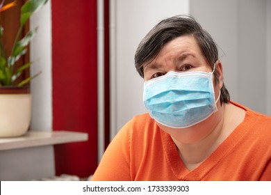 Mentally Disabled Woman Wearing A Surgical Mask, Covid-19 Or Corona, Coronavirus And Handicapped People