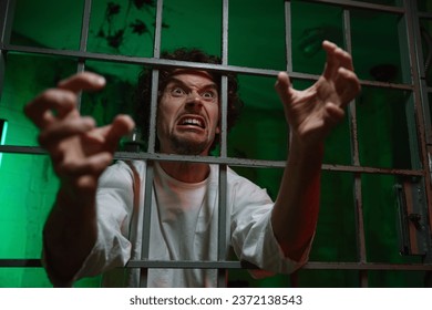 Mentally unstable male patient with attack of rabies locked in cage ward