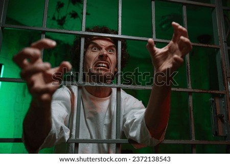Mentally unstable male patient with attack of rabies locked in cage ward