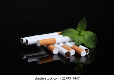 Menthol Cigarettes And Mint On Black Background