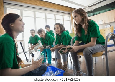 Mentor teaching students to recycle in classroom - Powered by Shutterstock