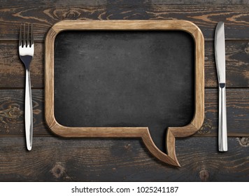 menu blackboard frame on wooden dinning table - Shutterstock ID 1025241187