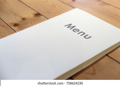 Menu Card Mockup In Leaflet Style For Restaurant, Cafe Or Bar. Empty Blank White Paper Menu Template On Wooden Table.