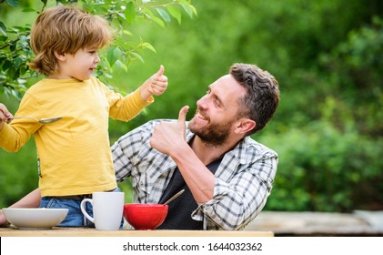 Menu For Children. Homemade Meal. Food Habits. Little Boy With Dad Eating Food Picnic Yard Nature Background. Summer Breakfast. Healthy Food Concept. Family Weekend. Father Son Eat Food And Have Fun.