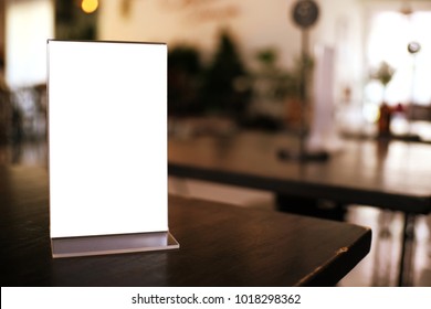 Menu frame standing on wood table in Bar restaurant cafe. space for text marketing promotion - Shutterstock ID 1018298362