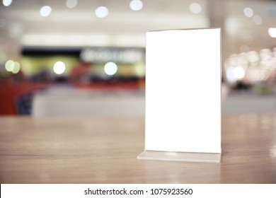 Menu frame standing on wood table in Bar restaurant cafe. space for text marketing promotion - Shutterstock ID 1075923560