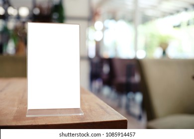 Menu frame standing on wood table in Bar restaurant cafe. space for text marketing promotion - Shutterstock ID 1085914457