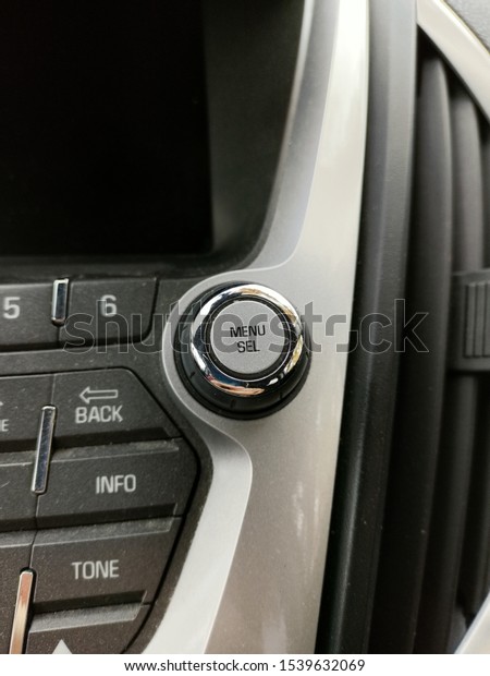 Menu and\
select knob on car entertainment\
system.