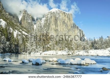 The Merced River looking into Yosemite Valley and El Capitan during the winter with snow. Yosemite National Park, California.