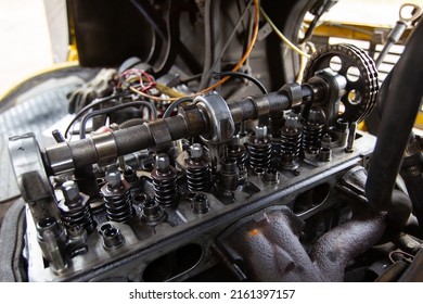 Mercedes diesel engine repair. Hands with a mechanic repairing Mercedes parts. The gas distribution mechanism of the fuel system of the car.